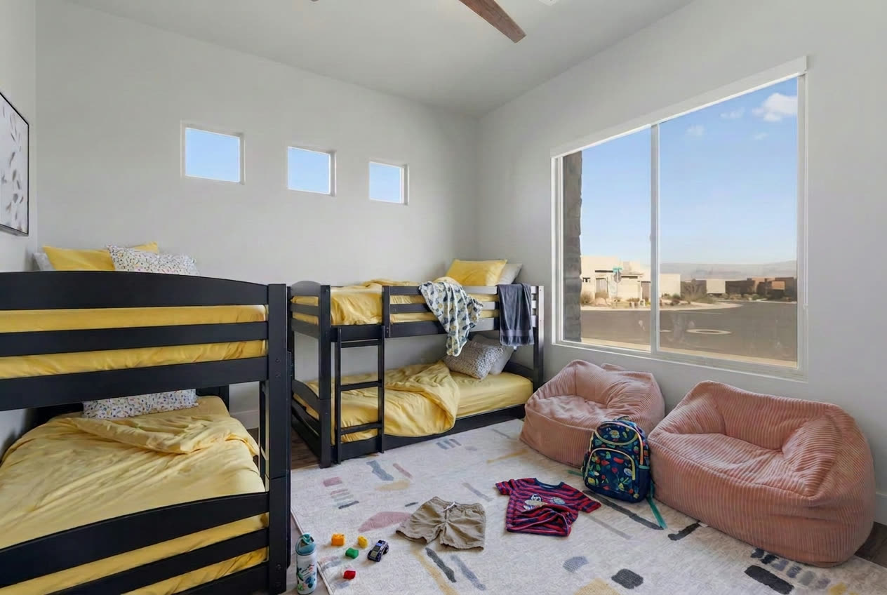 Kids bunk room with clothes and toys out before a TrueCove cleaning in Washington, Utah