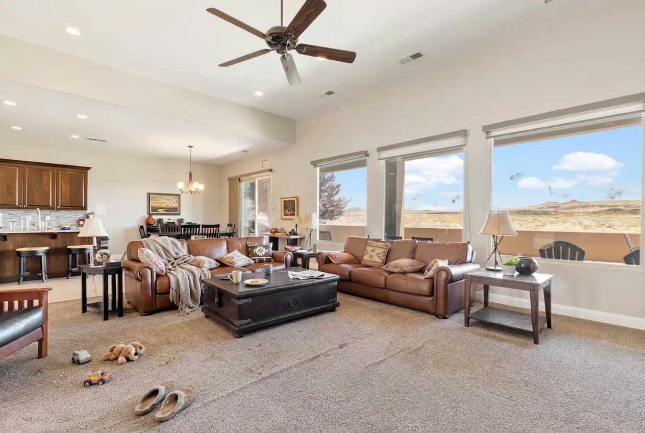 Lived-in great room with toys and clutter before a TrueCove cleaning in Ivins, Utah